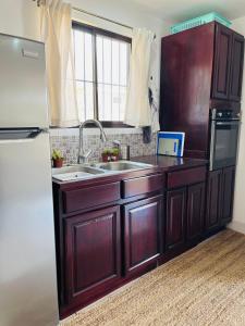 a kitchen with a sink and a refrigerator at Casa Blanca Beachhouse - walking distance beach in Tamarindo