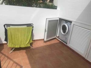 a laundry room with a washing machine next to a wall at La Tejita Beachhouse in La Tejita