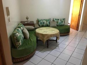 a living room with two couches and a table at Appartement spacieux à Agadir in Agadir