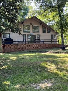 a house with a large yard in front of it at Hideaway - 3 BR Home with PRIVATE POOL on wooded lot in Montgomery