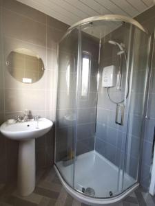 a bathroom with a shower and a sink at Ballywalter Beach House in Ballywalter