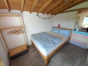 a small bedroom with a bed in a room at Cosy Private Cottage w/sea views & wifi in Vila do Porto