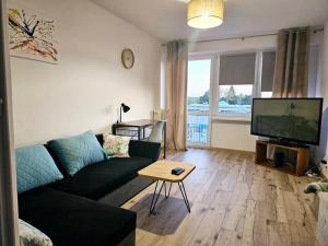 a living room with a couch and a flat screen tv at ParkHome in Stalowa Wola