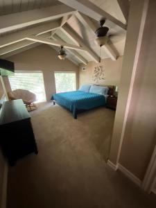 a bedroom with a blue bed in a room at Hideaway - 3 BR Home with PRIVATE POOL on wooded lot in Montgomery