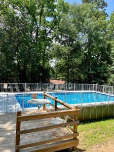 a picnic table in front of a swimming pool at Hideaway - 3 BR Home with PRIVATE POOL on wooded lot in Montgomery