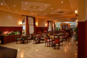 a restaurant with tables and chairs in a room at Aktea Beach Village in Ayia Napa