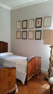 a bedroom with two beds and framed pictures on the wall at Cavour 45 in Vittuone