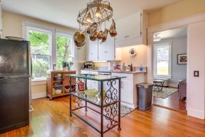 a kitchen with a table in the middle of a room at Historic and Charming Salem Home with Mill Creek Views! in Salem