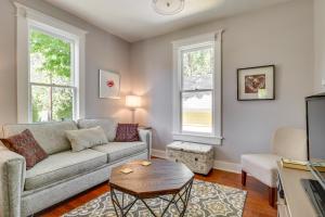 a living room with a couch and a table at Historic and Charming Salem Home with Mill Creek Views! in Salem