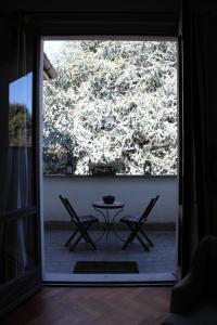 a patio with a table and chairs in front of a window at Cavour 45 in Vittuone