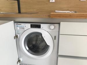 a white washing machine sitting in a kitchen at Аpartment Bella Vista in Obzor