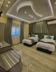 a hotel room with two beds and aception at Fragrant Rose in Wadi Musa