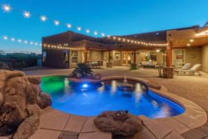 a house with a swimming pool in the yard at Quail Mountain Desert Resort: Heated Pool, Mt Vews, all BR's King & TV's, Hiking in Mesa