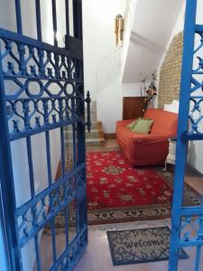a living room with a staircase and a red couch at la pigna bizantina in Ravenna