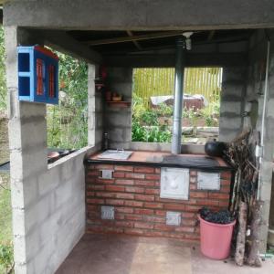a brick oven in a brick wall with a window at Soki in Guatapé