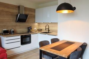 Kuchyň nebo kuchyňský kout v ubytování Apartmány Perla - Hotel Říčky