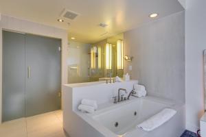 a bathroom with a tub and a sink and a mirror at Fort Lauderdale Condo with Veranda and Ocean View! in Fort Lauderdale +24 photos