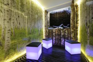 two stools in a room with a green wall at Hotel Saalbacher Hof in Saalbach-Hinterglemm