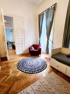 a living room with a couch and a chair at NEW LISTING IN THE HEART OF BUDAPEST Apartment Kamilla in Budapest