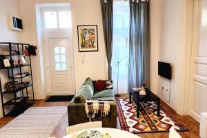 a living room with a couch and a table at NEW LISTING IN THE HEART OF BUDAPEST Apartment Kamilla in Budapest