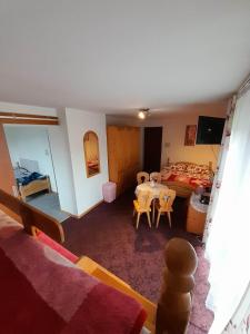 a room with a bed and a table and chairs at Lila in Bukowina Tatrzańska