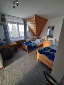a bedroom with two beds and a sink in it at Lila in Bukowina Tatrzańska