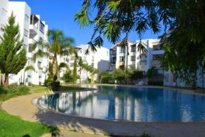 een groot zwembad voor sommige gebouwen bij Appartement Assilah marina golf in Asilah