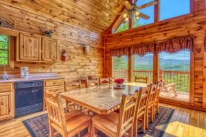 a dining room with a table and chairs in a cabin at Awesome Views #701 in Gatlinburg