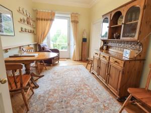 a living room with a table and a dining room at Grisedale View in Keswick