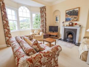 a living room with a couch and a fireplace at Grisedale View in Keswick