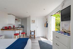 a bedroom with a bed and a kitchen with a counter at Pebbles by Bloom Stays in Sandgate