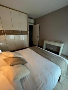 a bedroom with a large white bed with two pillows at Green Hill Penthouse apartment in Korčula +20 photos