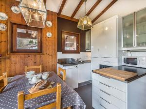 a kitchen with a table and a dining room at Confortable 3 pièces avec animaux admis à Megève Jaillet - FR-1-453-38 in Megève