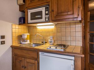 a small kitchen with a sink and a microwave at Studio Megève, 1 pièce, 4 personnes - FR-1-453-73 in Megève