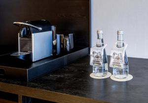 two bottles of water sitting on a counter next to a toaster at Radisson Pinheiros in São Paulo