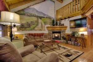 a living room with a couch and a fireplace at Lucky Logs #283 in Pigeon Forge
