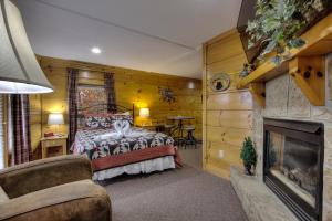 a bedroom with a bed and a fireplace at Lucky Logs #283 in Pigeon Forge