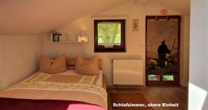 a small bedroom with a bed and a window at Ferienhaus hoch oben mit Alpen Panorama Königssee- Nichtraucherdomizil in Berchtesgaden