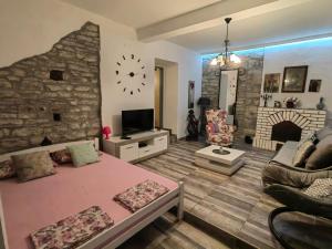 a large living room with a stone wall at Old House Morinj in Donji Morinj