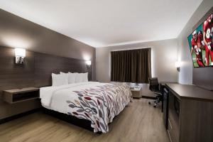 a hotel room with a bed and a desk at Red Roof Inn Sikeston - Marston in Marston