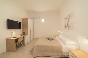 Postel nebo postele na pokoji v ubytování B&B MANDORLO BIANCO