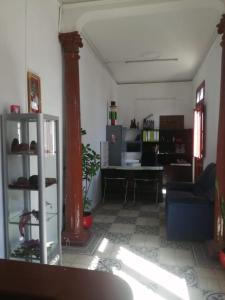 a living room with a blue couch and a table at pusary hostel in Arequipa