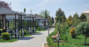 a park with a pavilion and a bench and trees at Sun City Hotel & Spa Naftalan in Naftalan