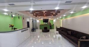 a lobby with green walls and a couch and a tv at Sun City Hotel & Spa Naftalan in Naftalan +39 photos
