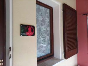 una porta con un cartello sopra accanto a una finestra di I Borghi di Michele - Il nido di Mennenne a Villasimius