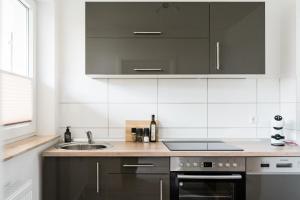a kitchen with a sink and a stove at Fischtown Apartment II in Bremerhaven