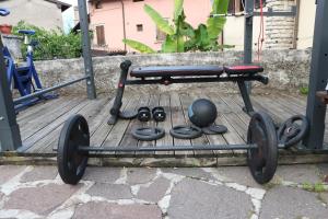 a exercise cart with weights on a wooden deck at B&B Casa Elena Room and Apartments with parking in Gargnano