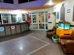 a lobby with couches and a tv in a building at بيت الشباب الاسماعيلية - Ismailia Youth Hostel in Ismailia