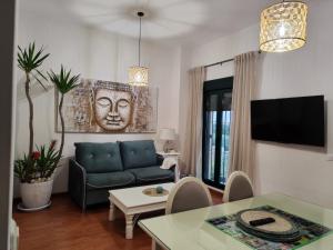 a living room with a couch and a table at Villa María Montecastillo Golf in Jerez de la Frontera