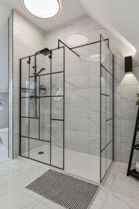 a shower with a glass door in a bathroom at Little Gleddoch in Dumbarton